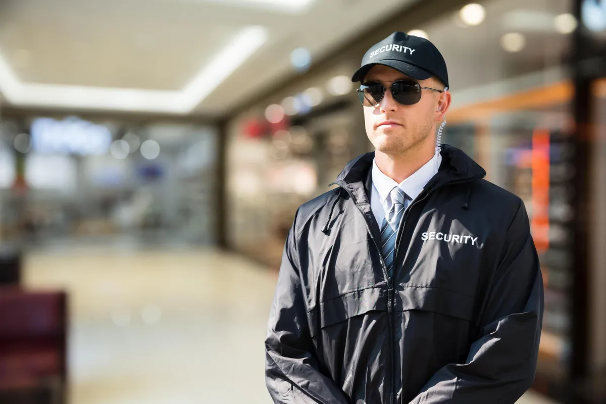 Uniformed security guard on duty inside a building
