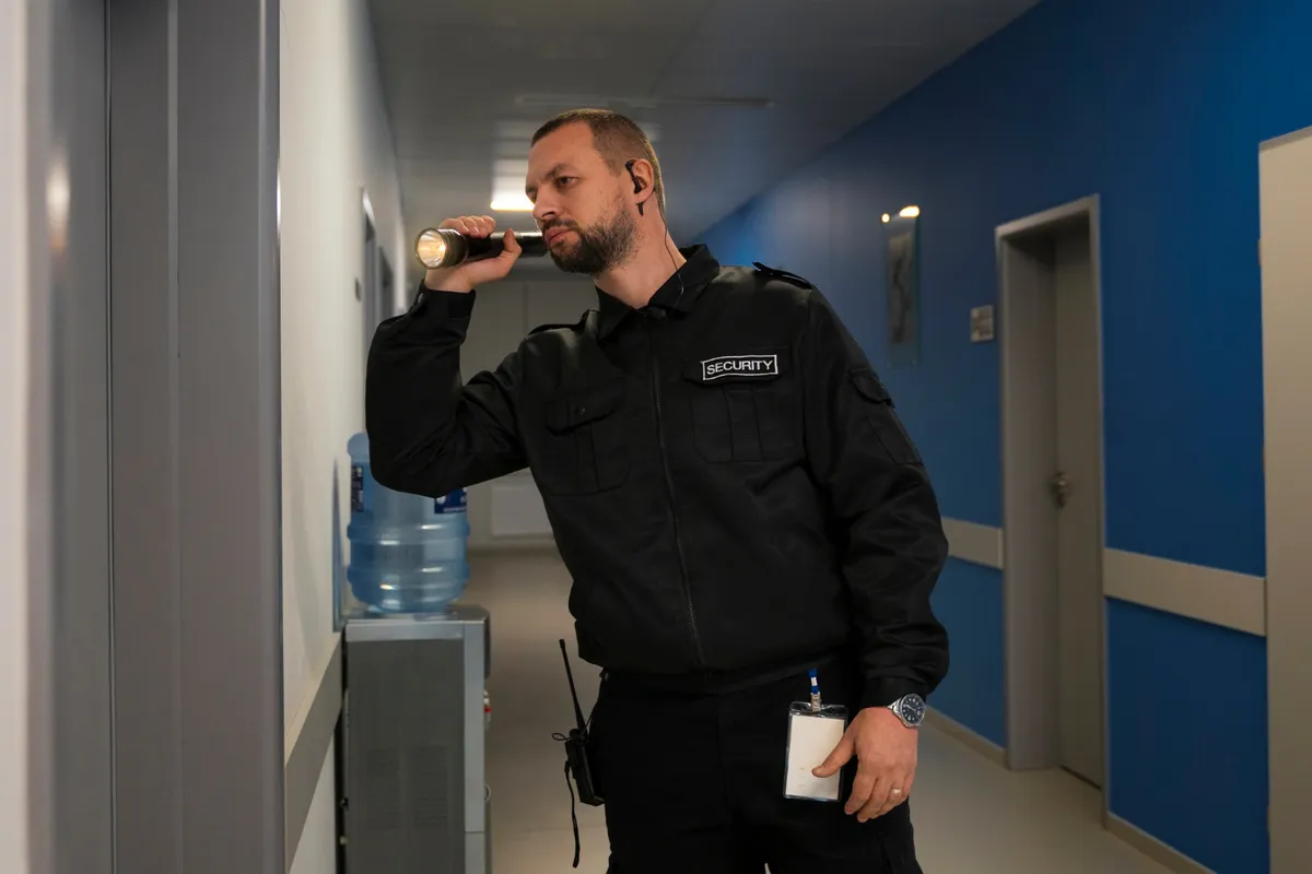 Security guard carrying out an indoor patrol